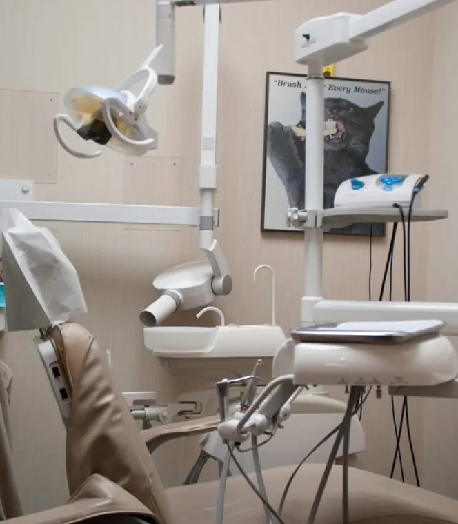 A treatment chair at North Shore Dental with an overhead light and x-ray arm.